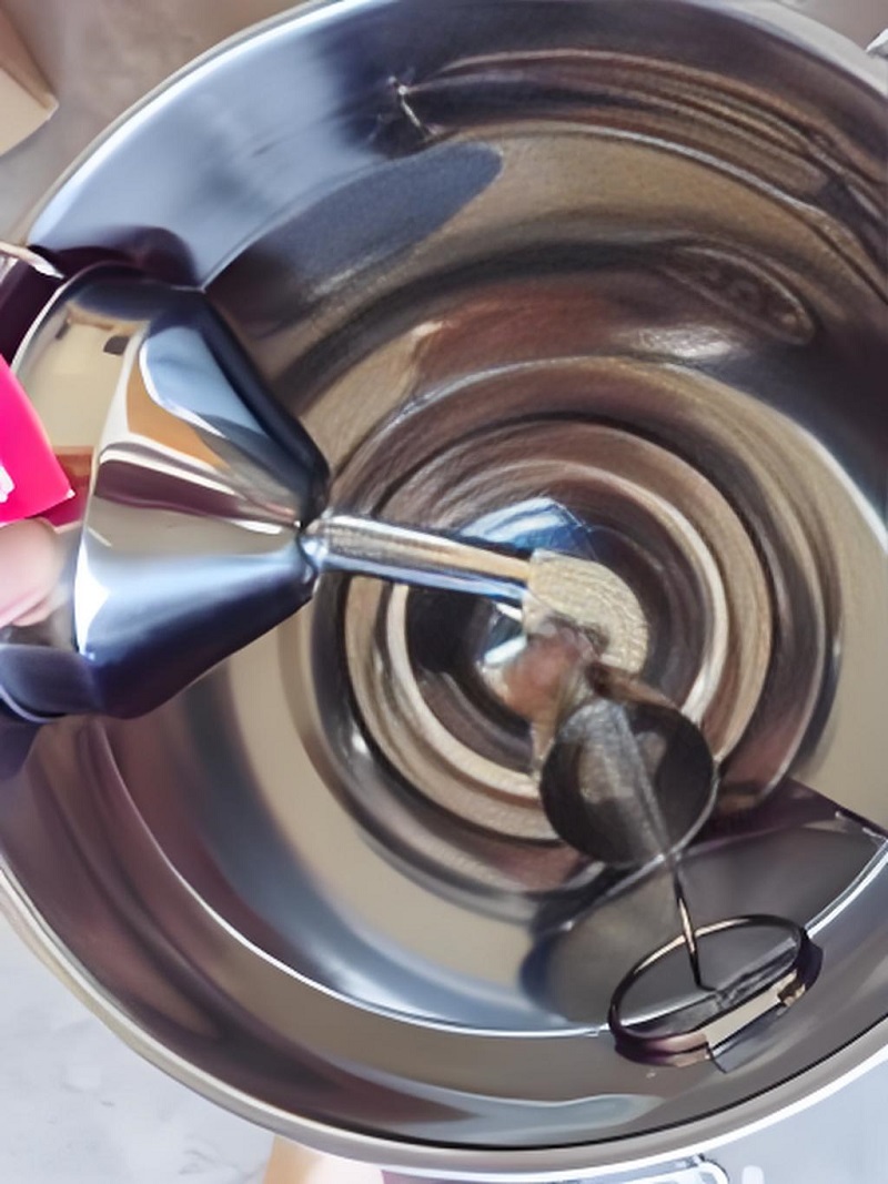 A dairy farm customer shows the inside of a stainless steel milk can that has been used for many years..jpg